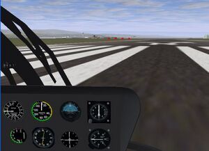 Sitting inside the Bo105 on the right side of the cockpit.